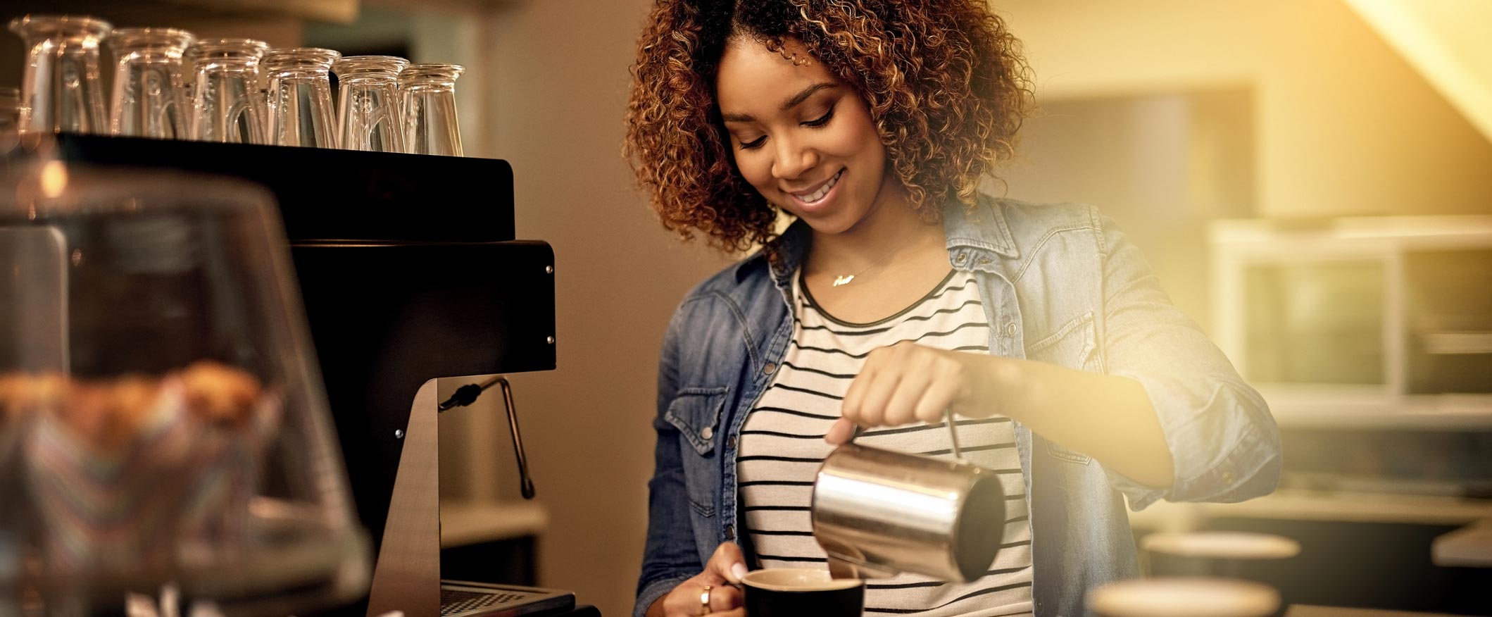 Female business owner pouring coffee