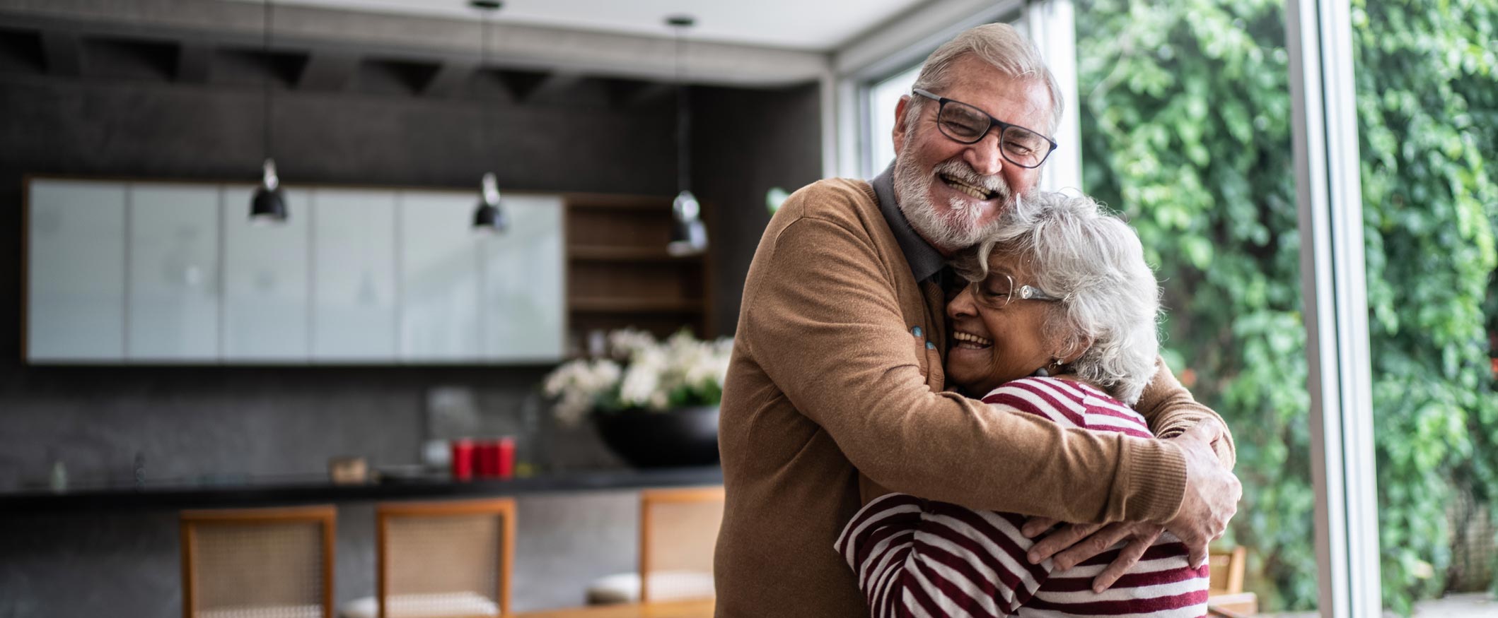 Mature couple hugging in living room