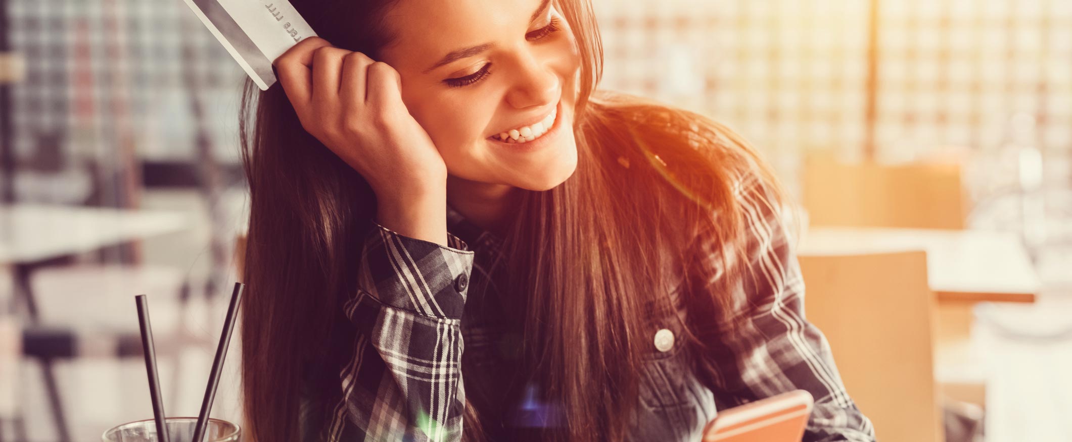 Young woman shopping online with debit card