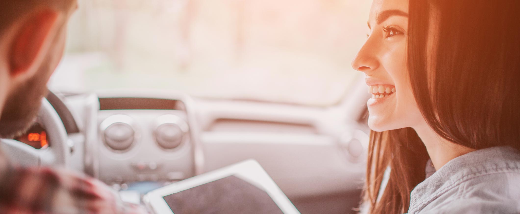 Young couple driving new car